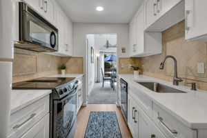 Natural light from the dining room windows and oversized skylight carries into the kitchen.
