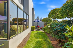 Green side yard leading to the garden patio.