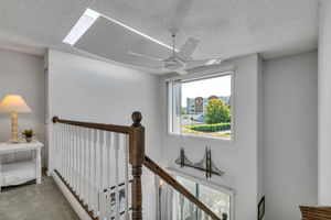 Open loft overlooks the main level beneath an oversized skylight with an adjustable shade.