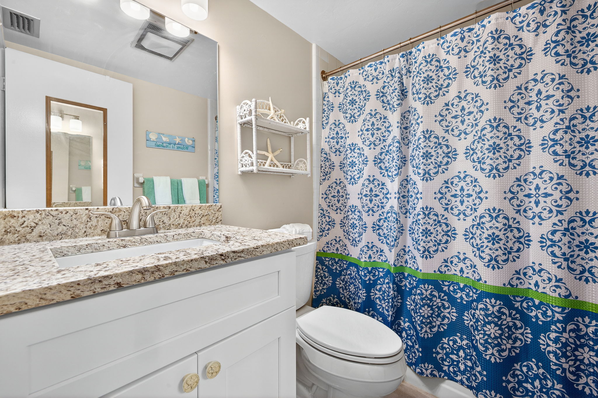Guest bath has new granite top vanity, mirror, lighting