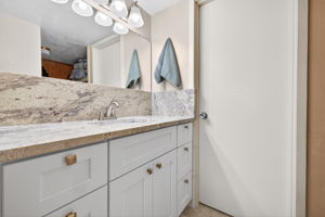 New granite topped vanity, mirror, lightiing backsplace