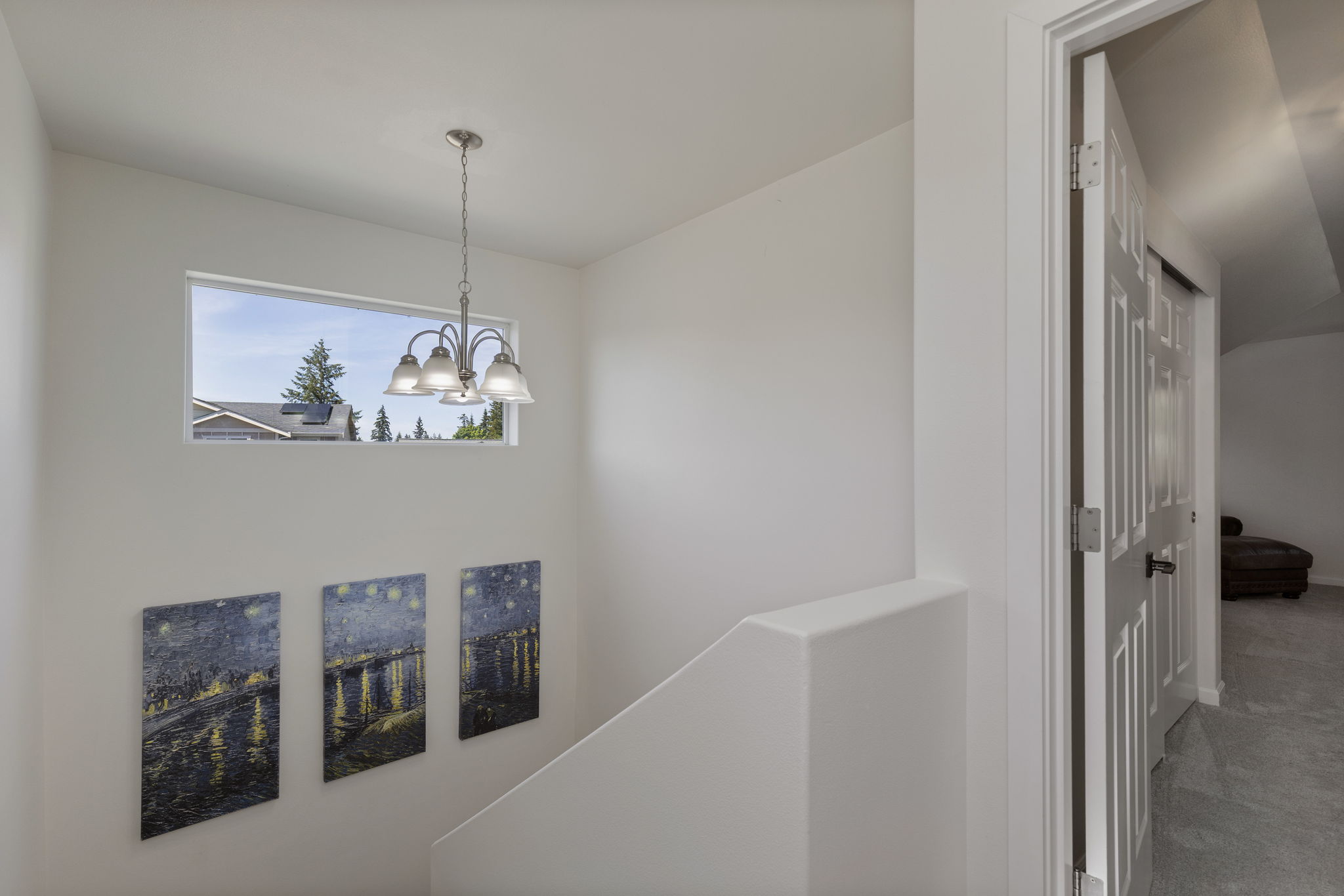 Stairway and landing to upper level primary suite!
