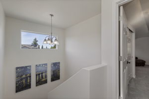 Stairway and landing to upper level primary suite!