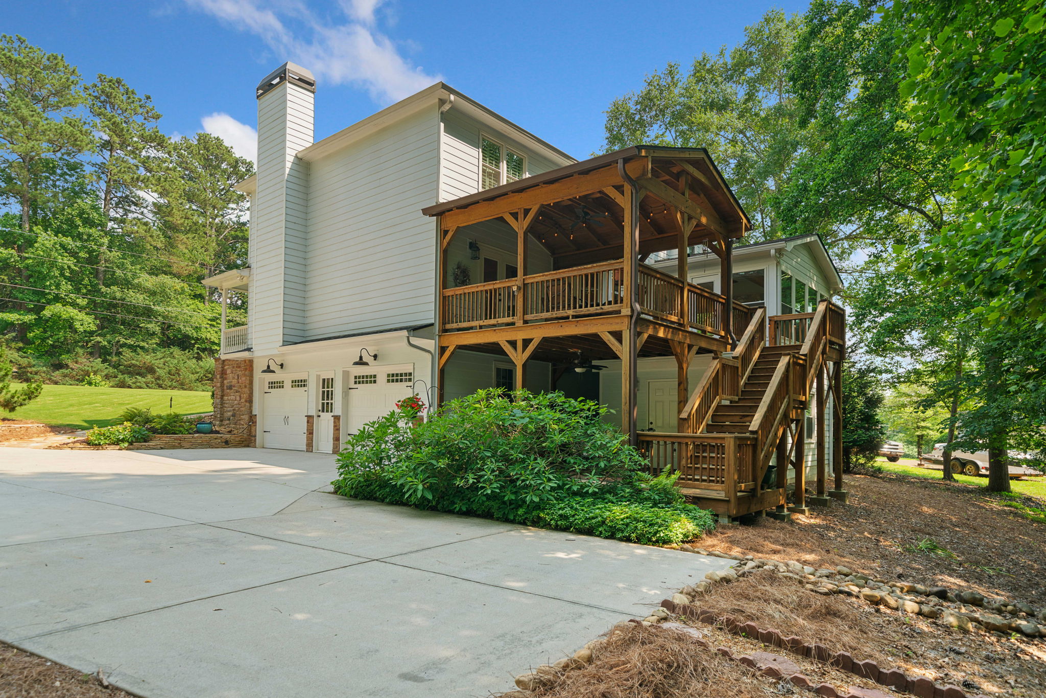 View of Back of home-garage-parking pad and that amazing covered deck