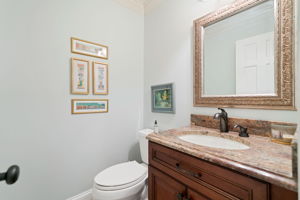 Powder Room tucked privately between office and kitchen