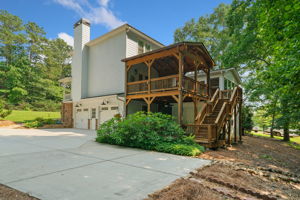 View of Back of home-garage-parking pad and that amazing covered deck