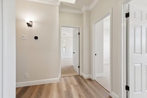 View of primary bedroom and bedroom 2 and bedroom 3 doorways