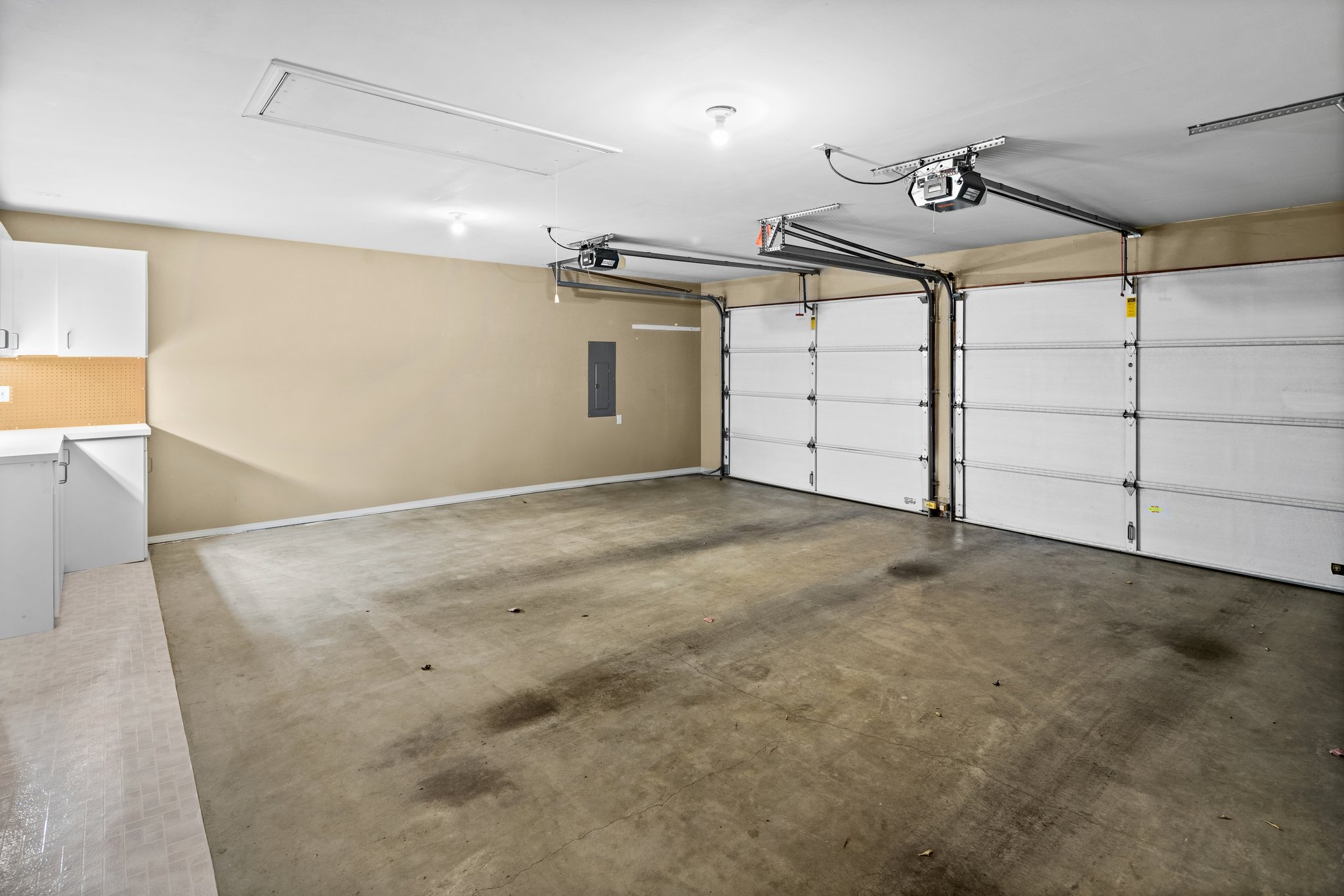 2 car garage with attic storage and build-in shop area