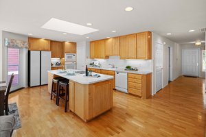 Island features a prep sink, cooktop and counter seating