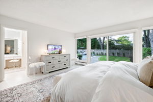 Primary bedroom with sliders to the yard