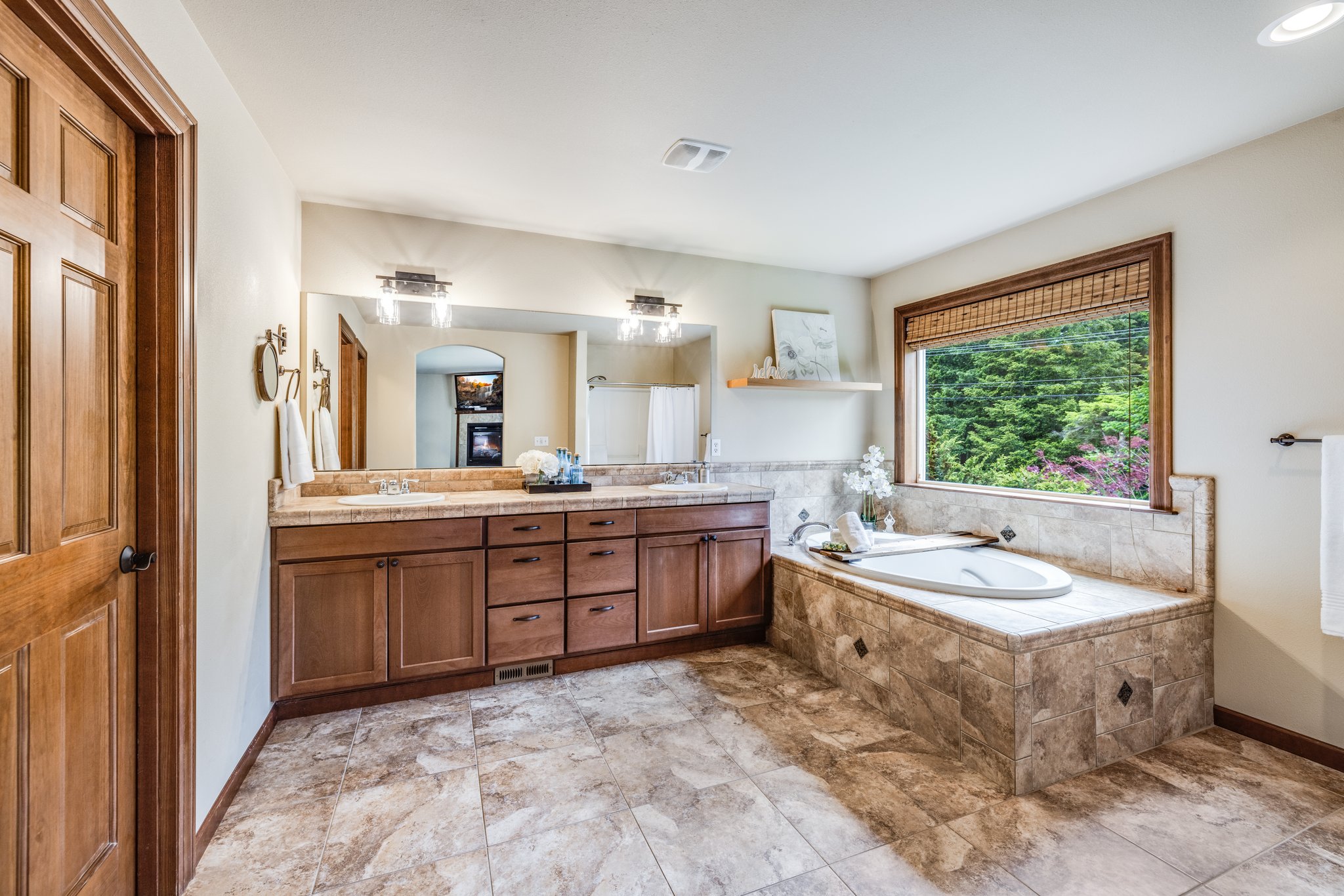 Primary Bathroom with double sinks, large soaking tub & lovely tile