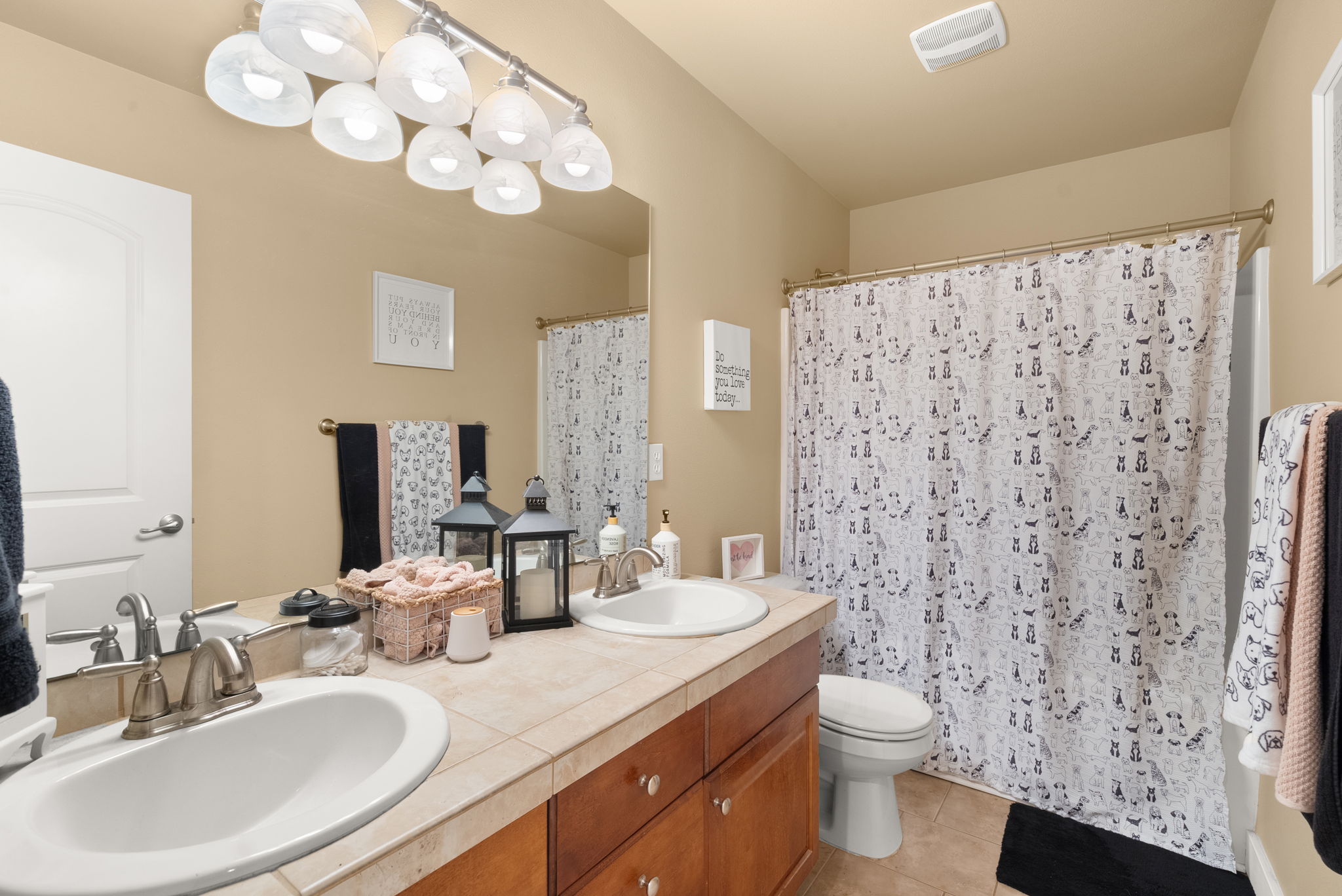 Full second-level bathroom with tile finishes.