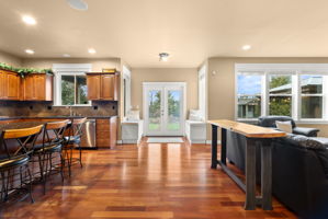 Off the open concept kitchen, there are French doors that lead to a gorgeous backyard. This design enhances the connection between the indoor living space and the outdoor area, creating an inviting and spacious environment. The French doors allow for ample natural light and fresh air, making the kitchen feel even more expansive. The beautiful backyard provides a stunning backdrop and an ideal spot for outdoor enjoyment, whether it's entertaining guests, relaxing, or simply appreciating nature.