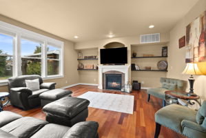 Light-filled living room with natural gas fireplace for year-round comfort.