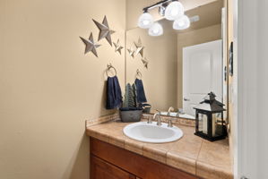 Guest-friendly powder room showcasing tile details.