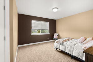 Spacious additional bedroom overlooking the backyard with walk-in closet.