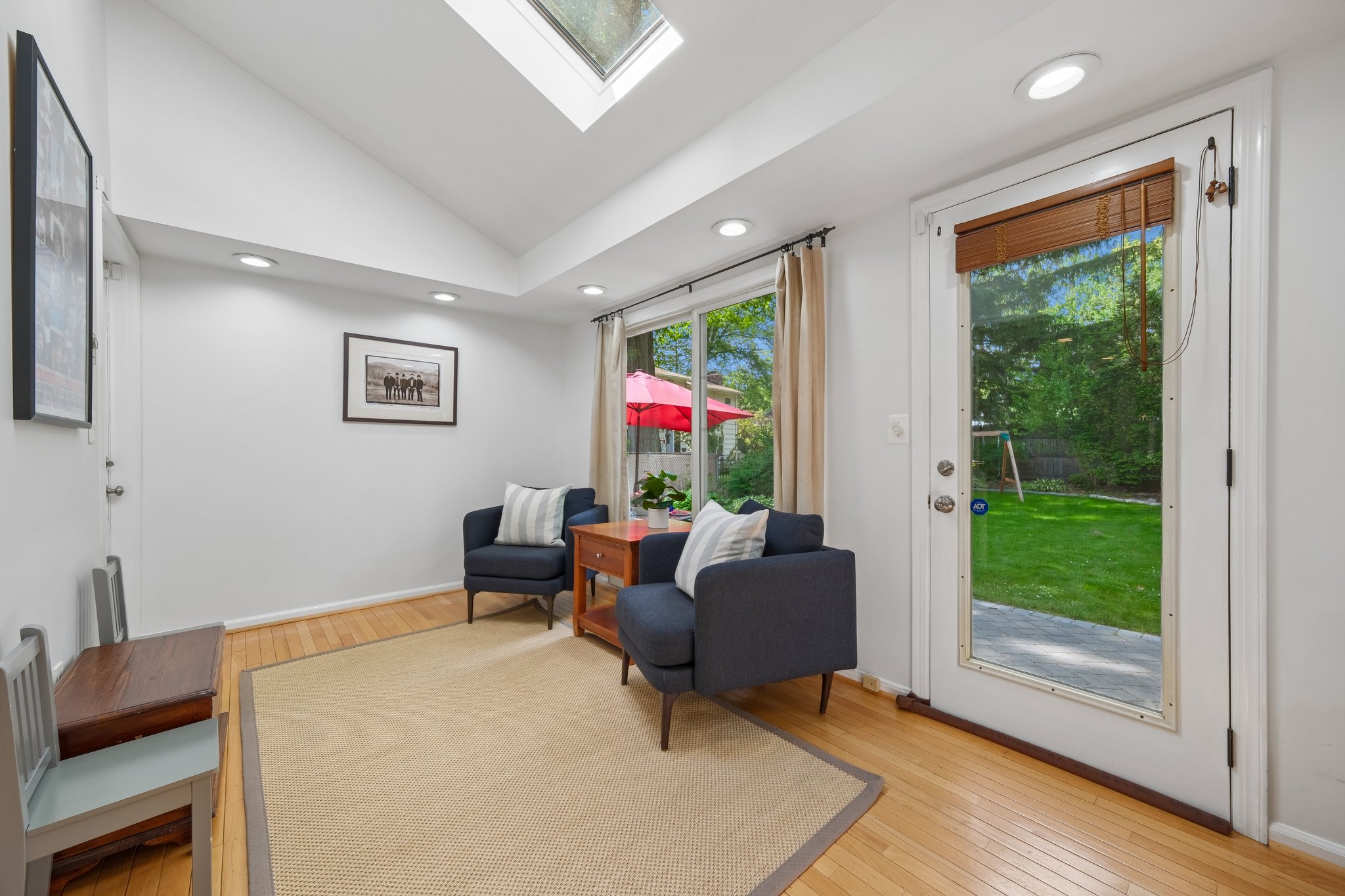 A skylight overhead and garden views beyond the windows make this den feel bright, calming, and connected to nature all day long.