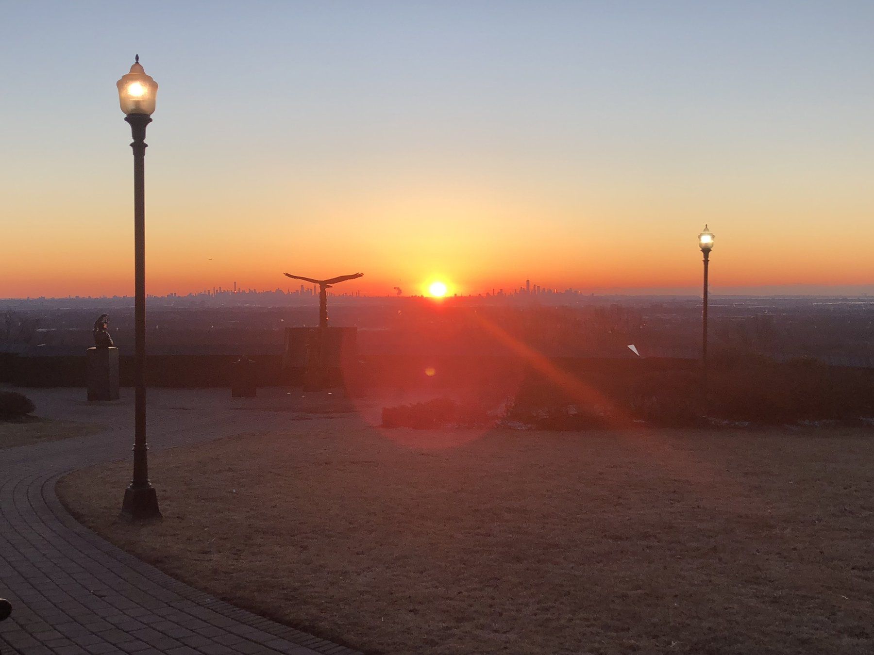 Sunrise behind the NYC skyline from Eagle Rock Reservation which boasts 400 acres of hiking trails.
