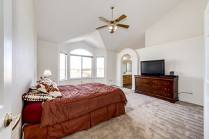 Primary bedroom with vaulted ceilings