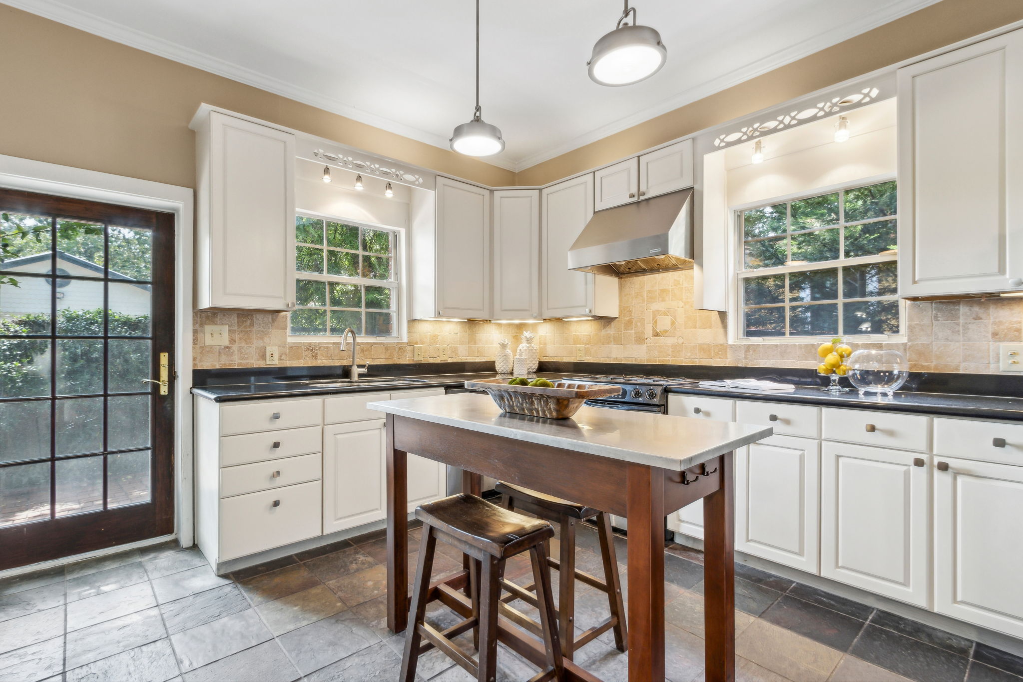 ... highlighted by white cabinets set against sleek black granite.