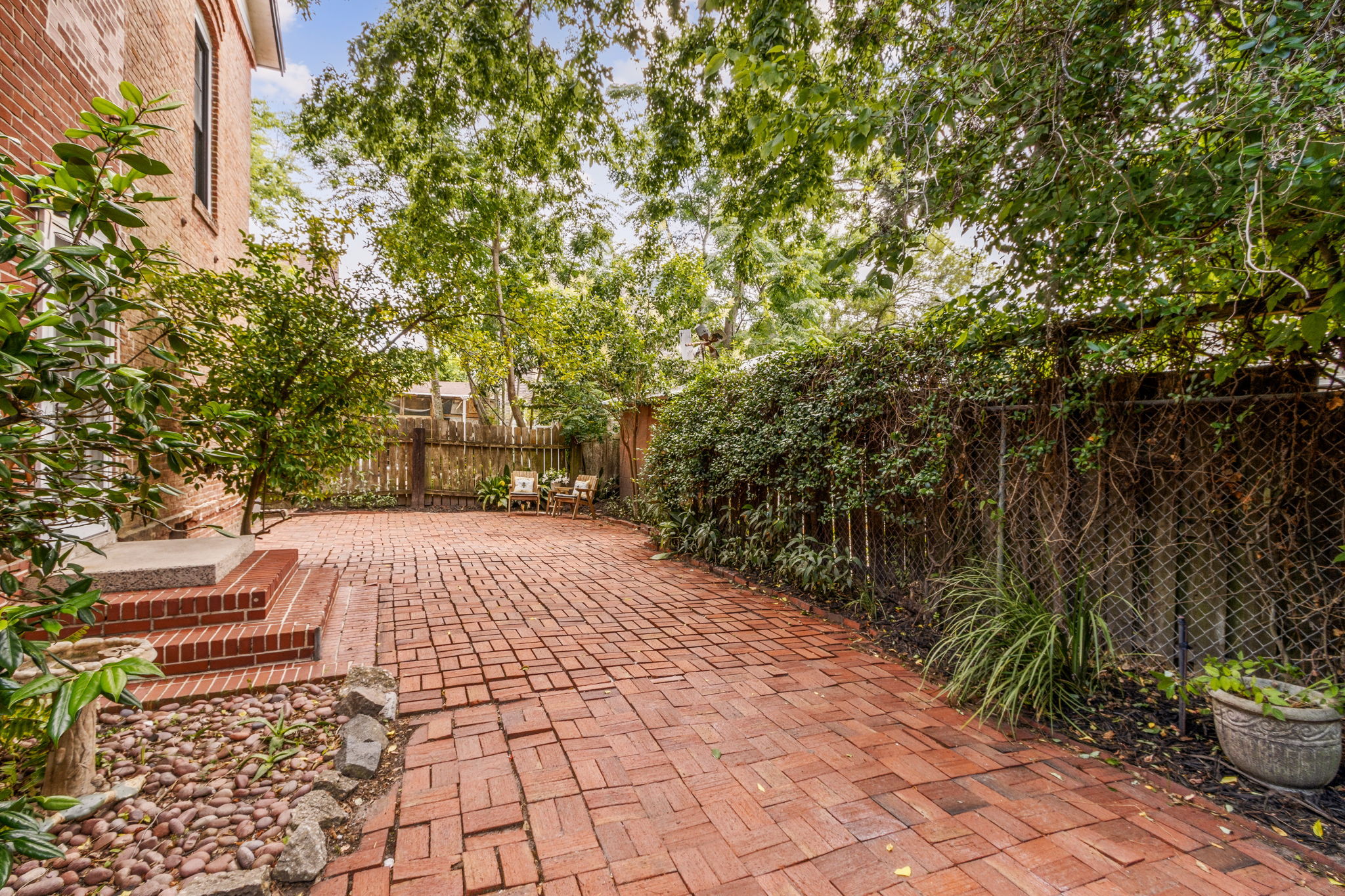 Charming landscaping surrounds the home, accented by two orange-producing trees...