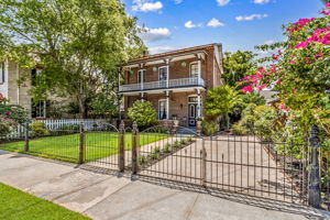 ... The lush, flower-laden yard is anchored by a historic gate true to the home’s era.