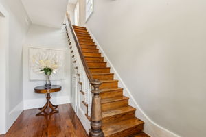 An authentic period staircase featuring original spindles, handrail, and stately newel posts.