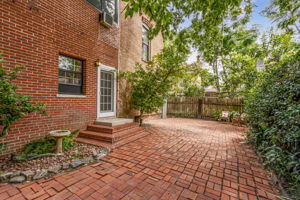 Out back, the expansive brick courtyard offers endless possibilities ...