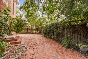 Charming landscaping surrounds the home, accented by two orange-producing trees...