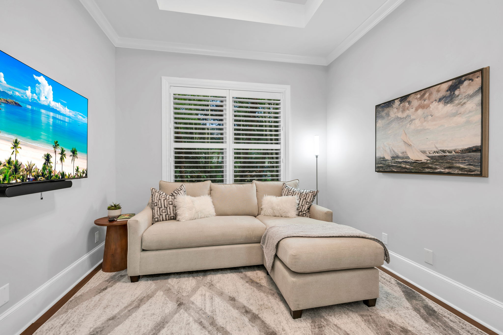 Den/Office currently set up as a media room with plantation shutters.