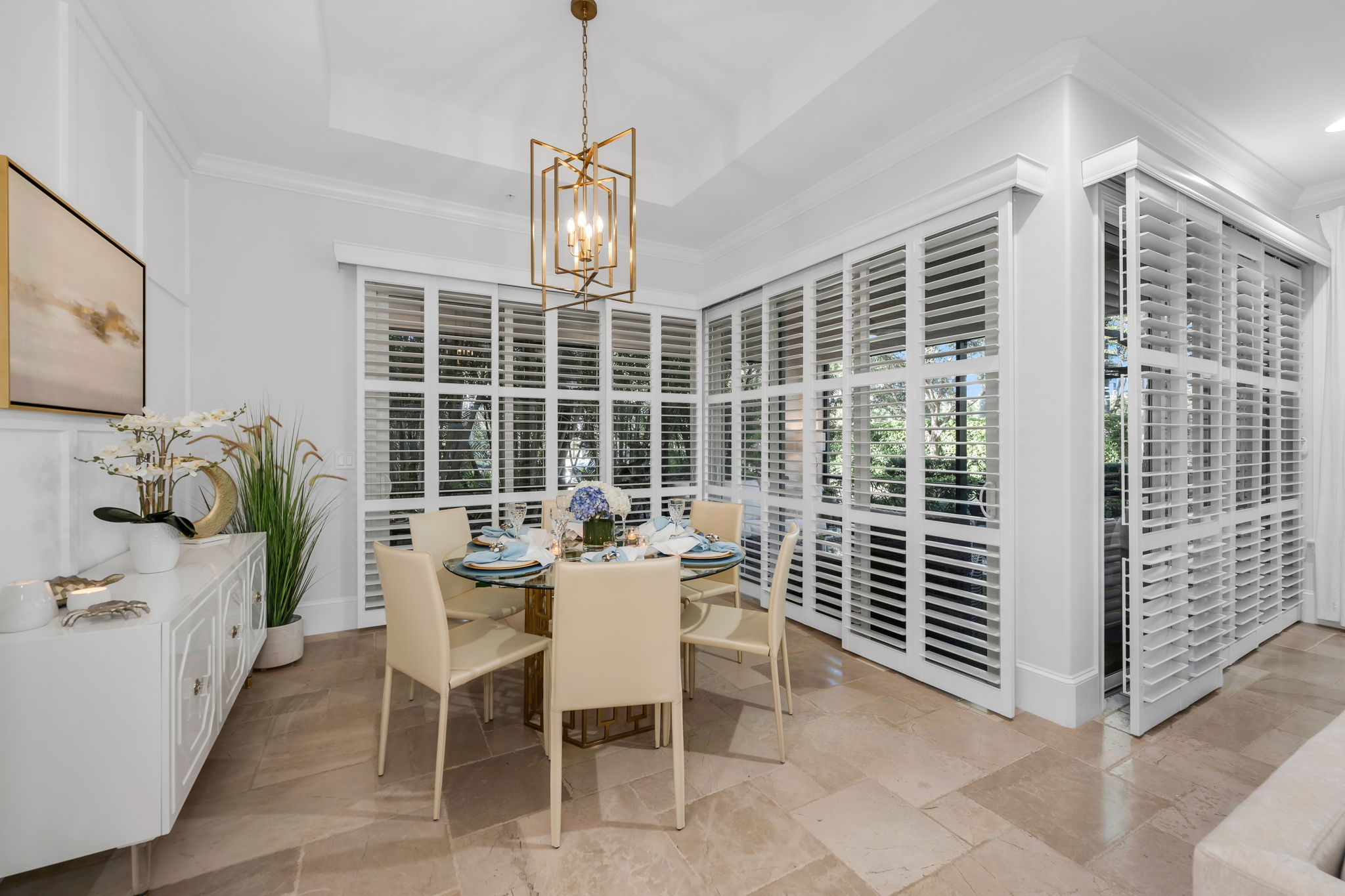 Large dining room with plantation shutters and views to the lanai.