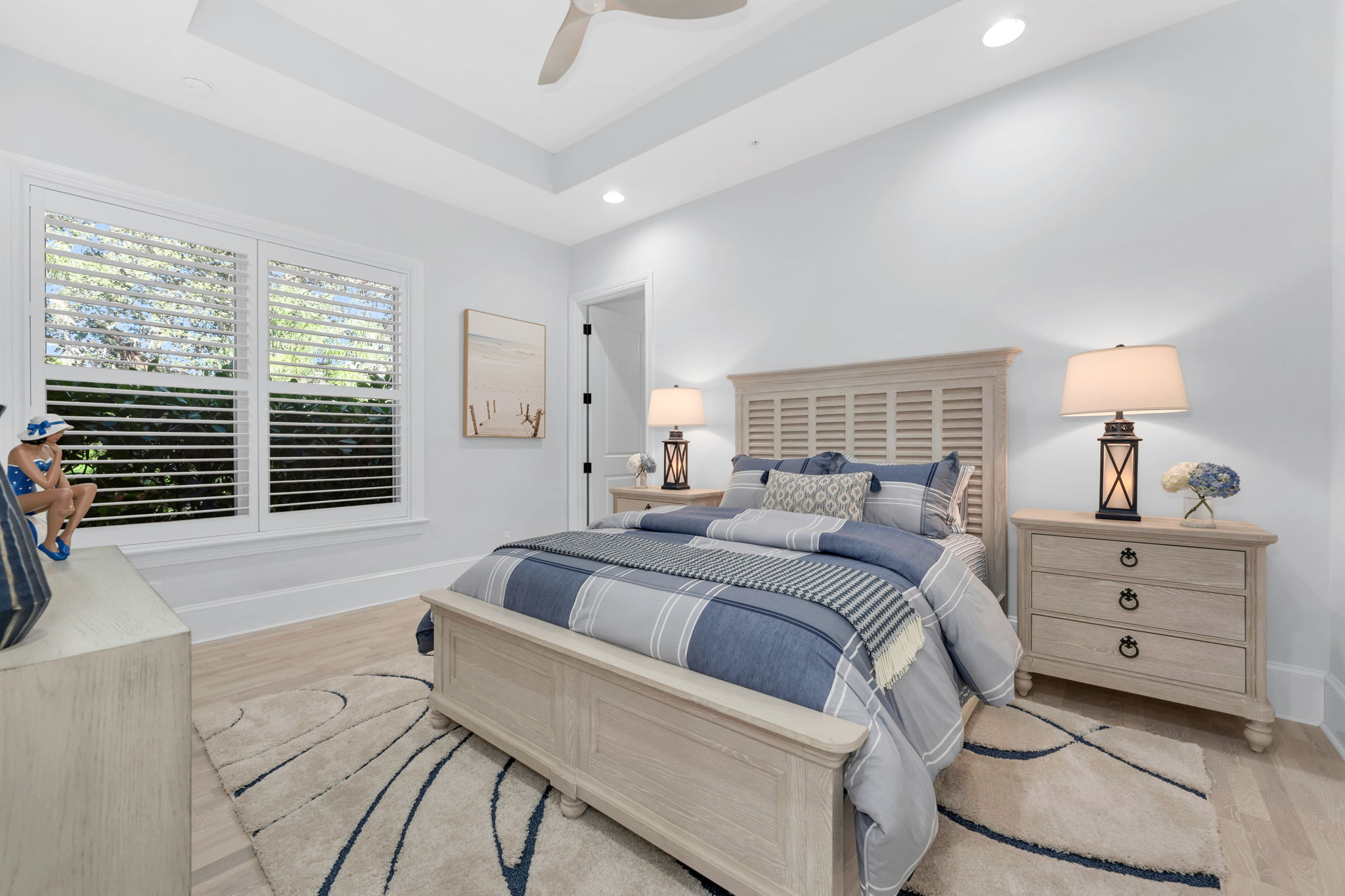Secondary guest bedroom with plantation shutters, new wood plank flooring, and a large walk in closet.