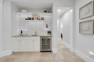 Wet bar with wine cooler, sink and ample storage.