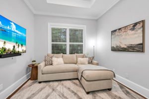 Den/Office currently set up as a media room with plantation shutters.