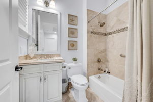 Secondary guest bathroom with shower and tub combination.