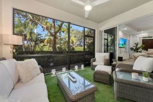 Main screened lanai with artificial grass and fountain.