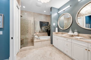 Dual vanities with separate soaking tub and shower.