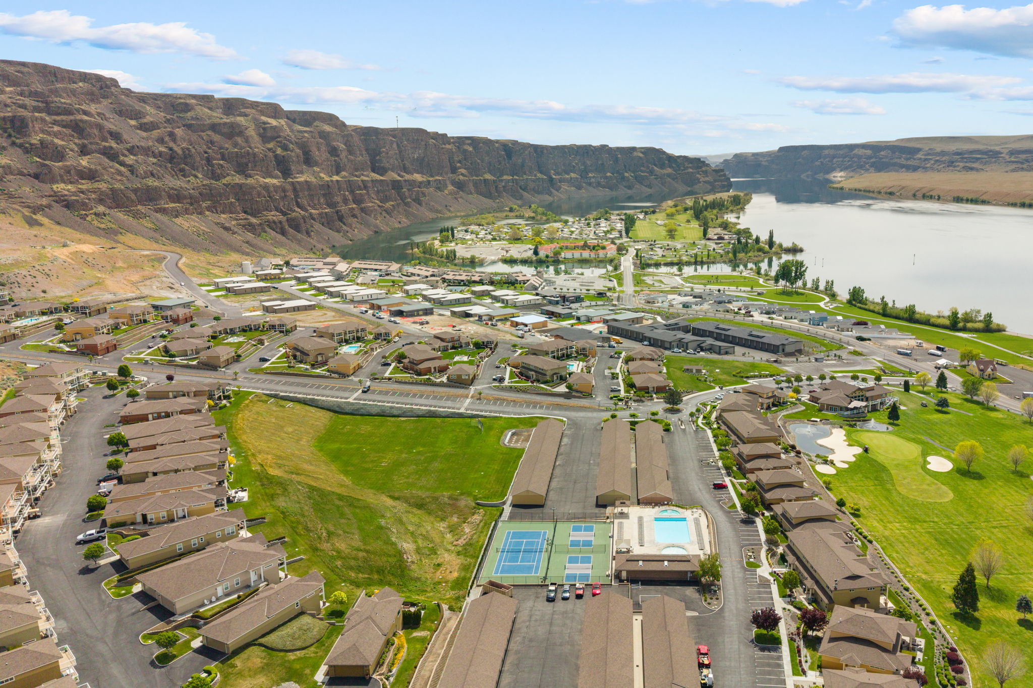 Resort-style amenities featuring a pool, hot tub, and sport courts create the perfect setting for leisure and recreation.