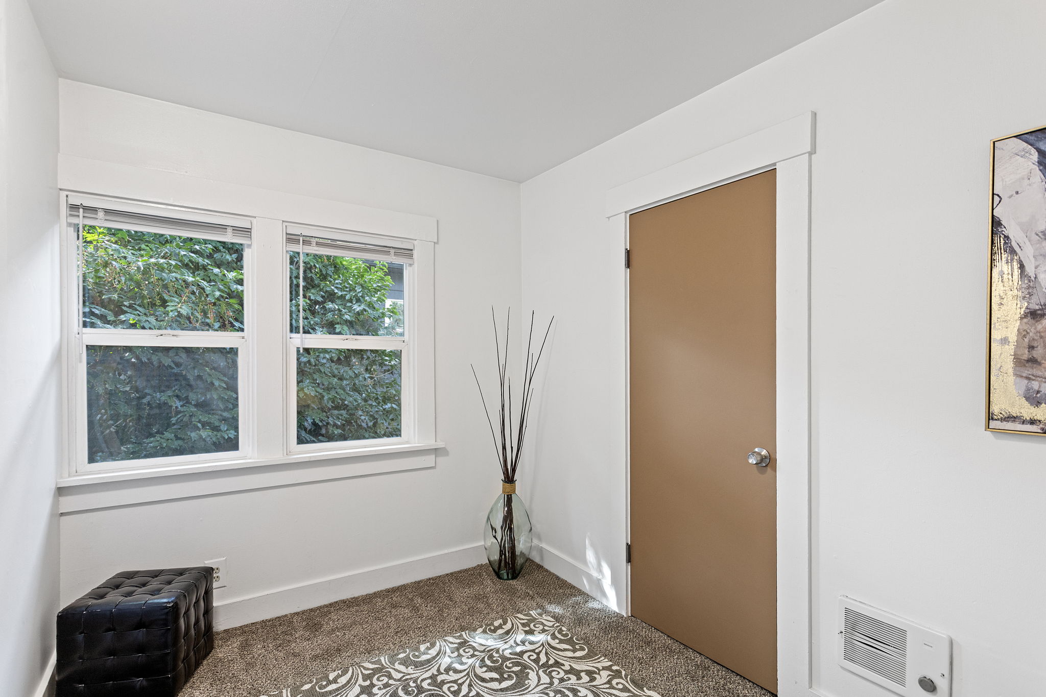 Two south-facing windows give the bonus room a leafy outlook over the backyard.