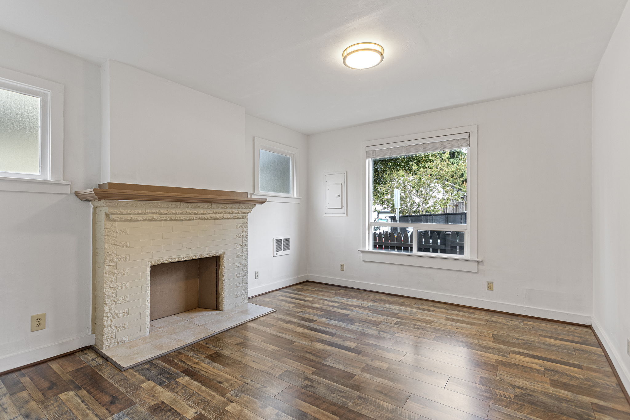 Unit B – Main Floor: high ceilings and three windows give the living room a noticeably more open feel.