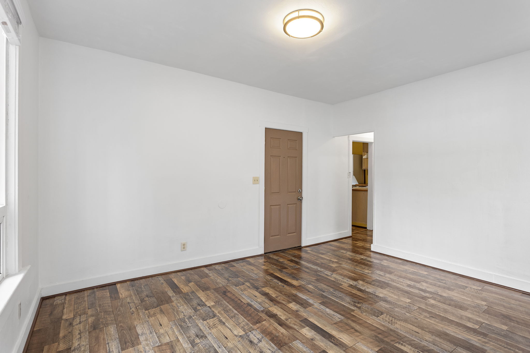 he south wall near the front door provides the natural spot for a dining table, just outside the kitchen