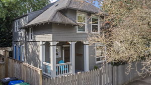 1906 Central Area duplex with a covered front porch and fully fenced frontage.