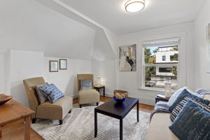 Unit A – Upper: street-facing living room with a broad front window.
