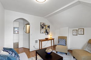 A simple arched opening adds a touch of 1906 character between the living room and hall.