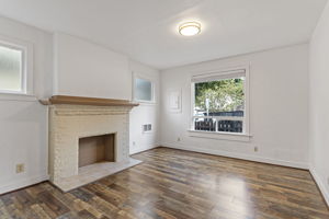 Unit B – Main Floor: high ceilings and three windows give the living room a noticeably more open feel.