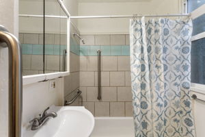 A south-facing window brings daylight to the full bath.
