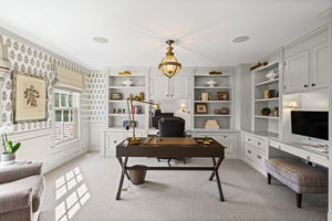 Office with built-in cabinets and shelves