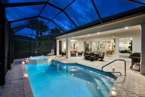 A view of the full pool deck and lanai during the evening.