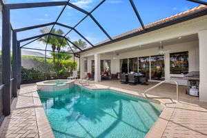 A view of the full pool deck and lanai during the day.