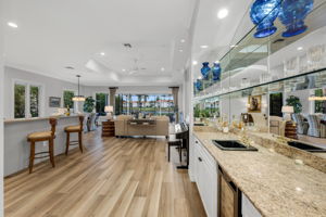 The wet bar includes storage, a beverage cooler, and easy access to the kitchen.